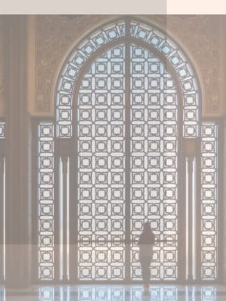 Soaring arches and patterned light inside a mosque — a symbol of hope and rising independence.